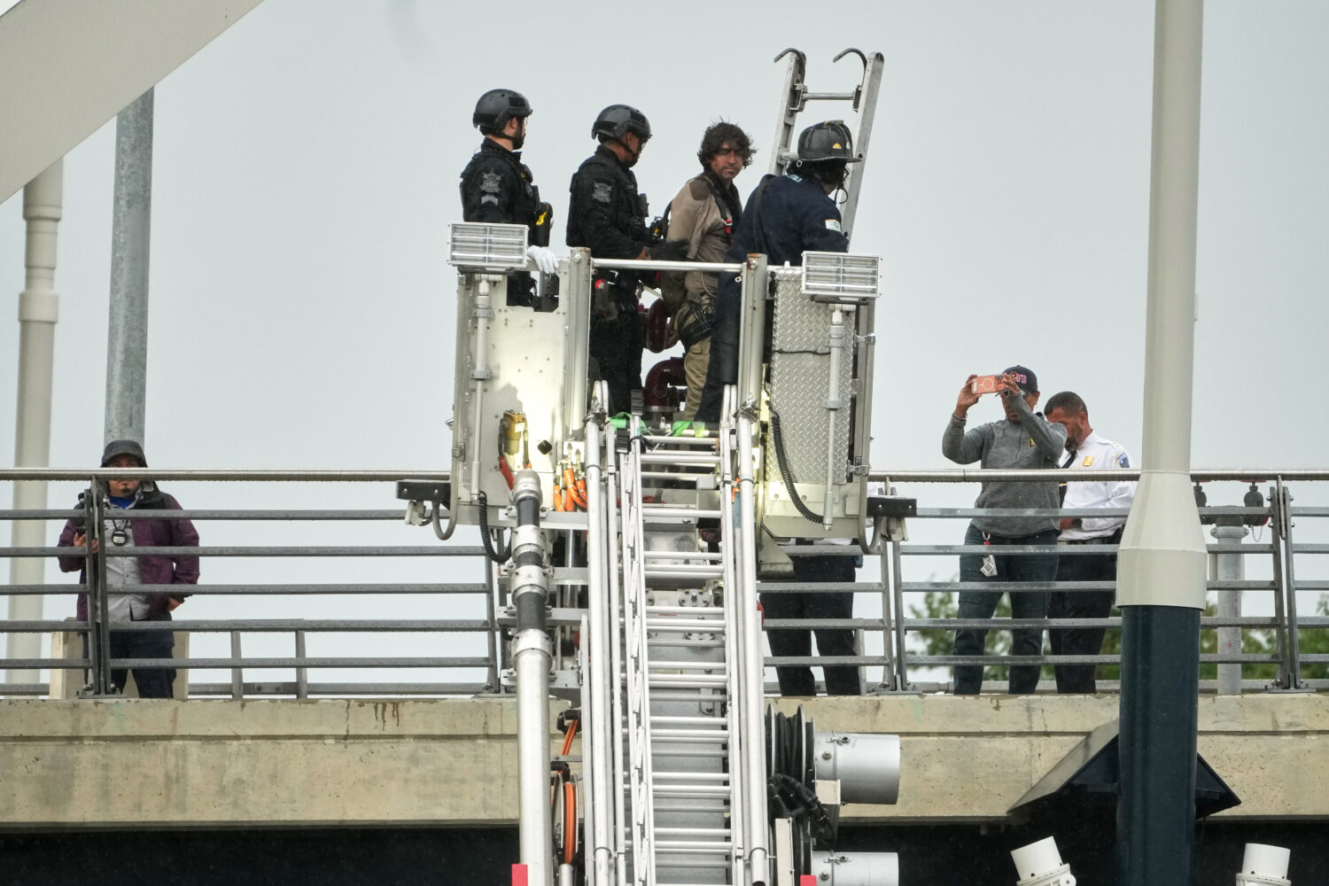 Emergency personnel remove Guido Reichstadter, 45, off the Frederick Douglass Bridge, Wednesday, Ma...