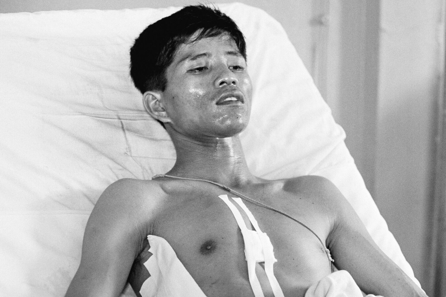 FILE - Dang Van Phuoc, 22, a Vietnamese photographer working with the Associated Press, lies in a b...