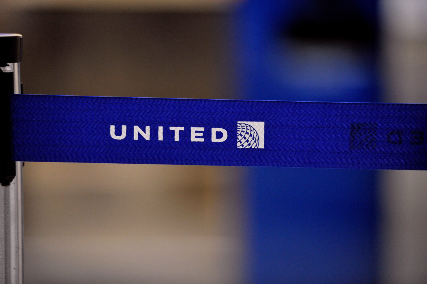 FILE - The United Airlines logo can be seen on a rope line at O'Hare International Airport, May 17,...