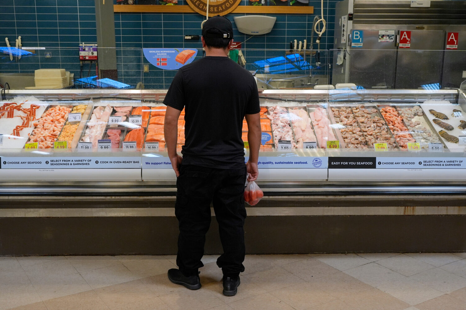 A person looks at the fresh fish at a grocery store Monday, May 11, 2026, in Nashville, Tenn. (AP P...
