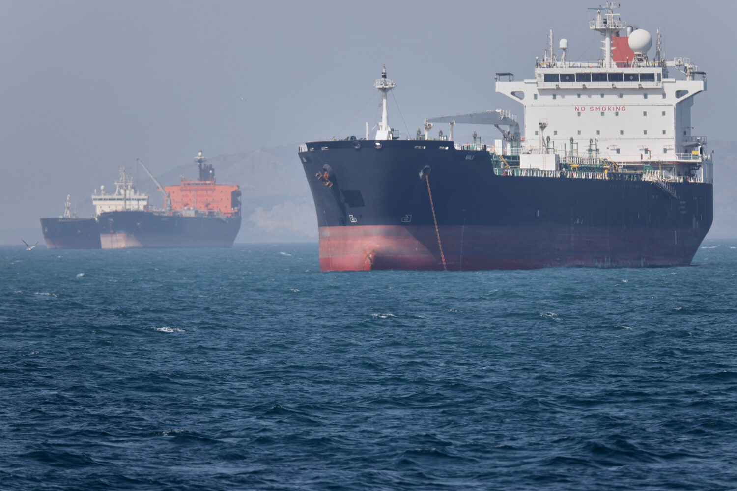 Oil tankers sit at anchor offshore in the Strait of Hormuz off Bandar Abbas, Iran, Saturday, May 2,...