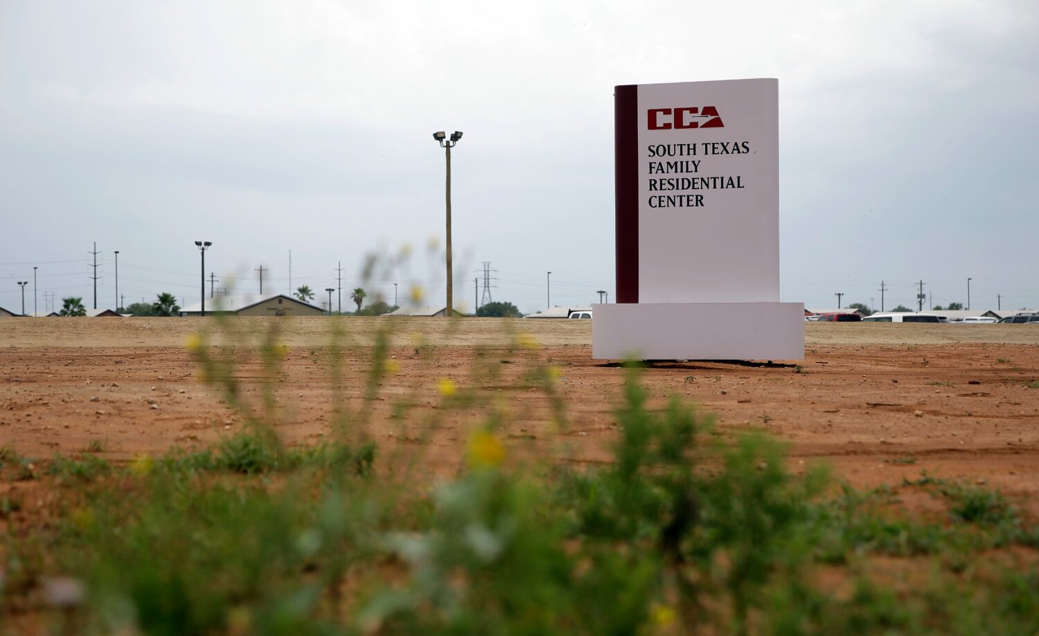 FILE - A sign stands at the entrance to the South Texas Family Residential Center in Dilley, Texas....