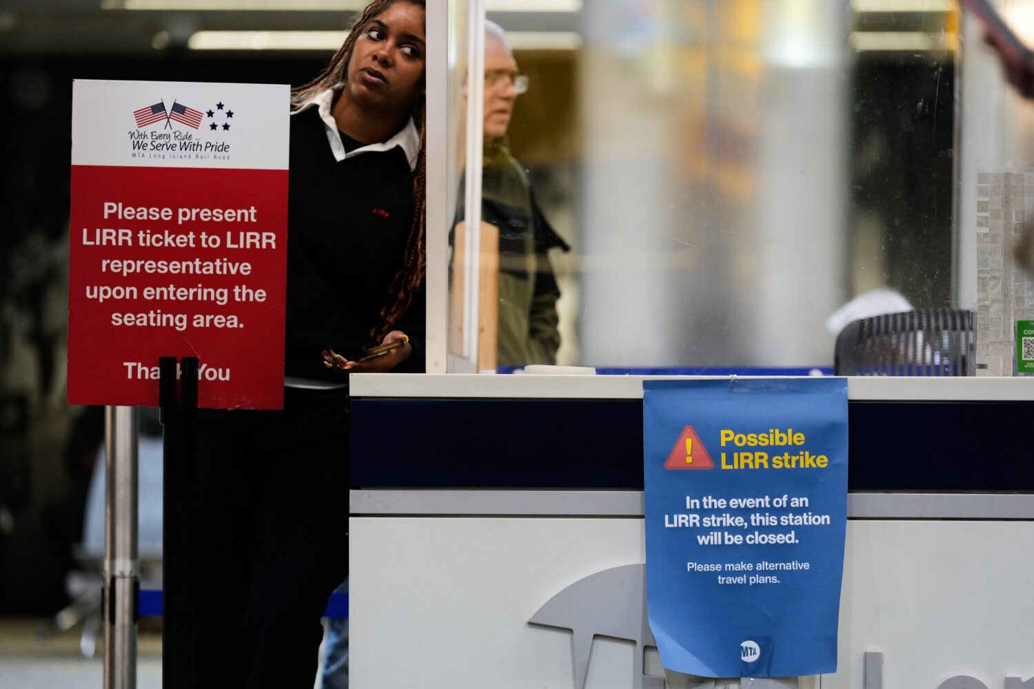 A sign warns commuters of a potential Long Island Rail Road strike at Penn Station in New York, Thu...