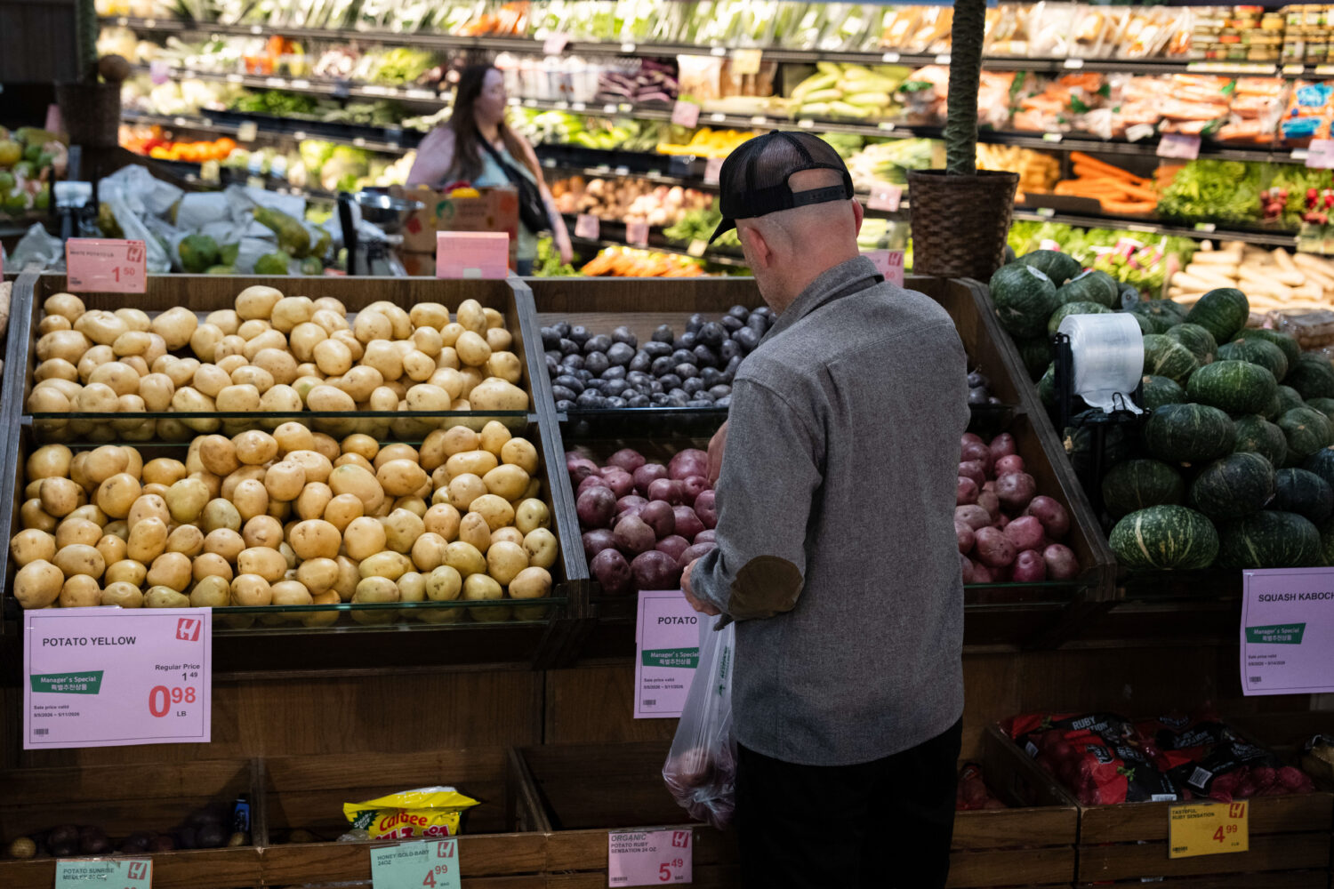Customers shop in the produce section of a grocery store on Monday, May 11, 2026, in Portland, Ore....