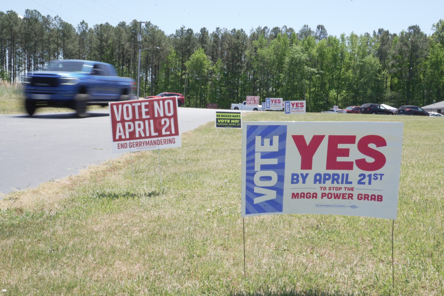 FILE - A truck passes political signs outside a polling place at Good Shepherd Catholic Church in S...