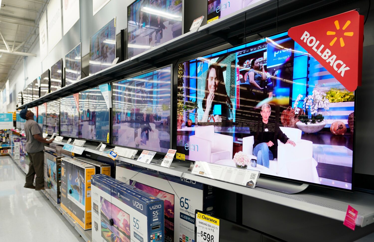 FILE - In this Nov. 9, 2018, file photo shoppers look at televisions at a Walmart Supercenter in Ho...