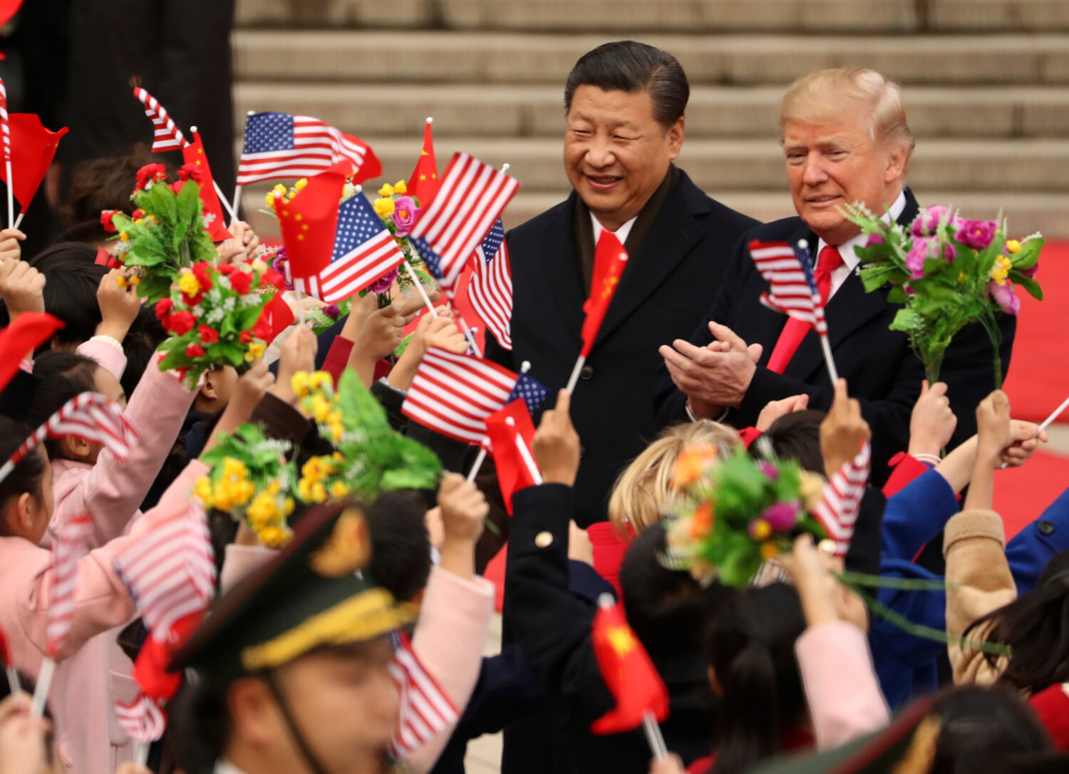 FILE - President Donald Trump and Chinese President Xi Jinping participate in a welcome ceremony at...