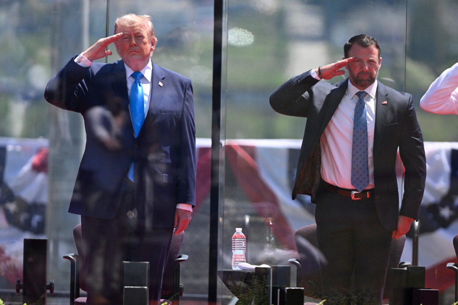 President Donald Trump, left, and Secretary of Homeland Security Markwayne Mullin, right, saluting ...