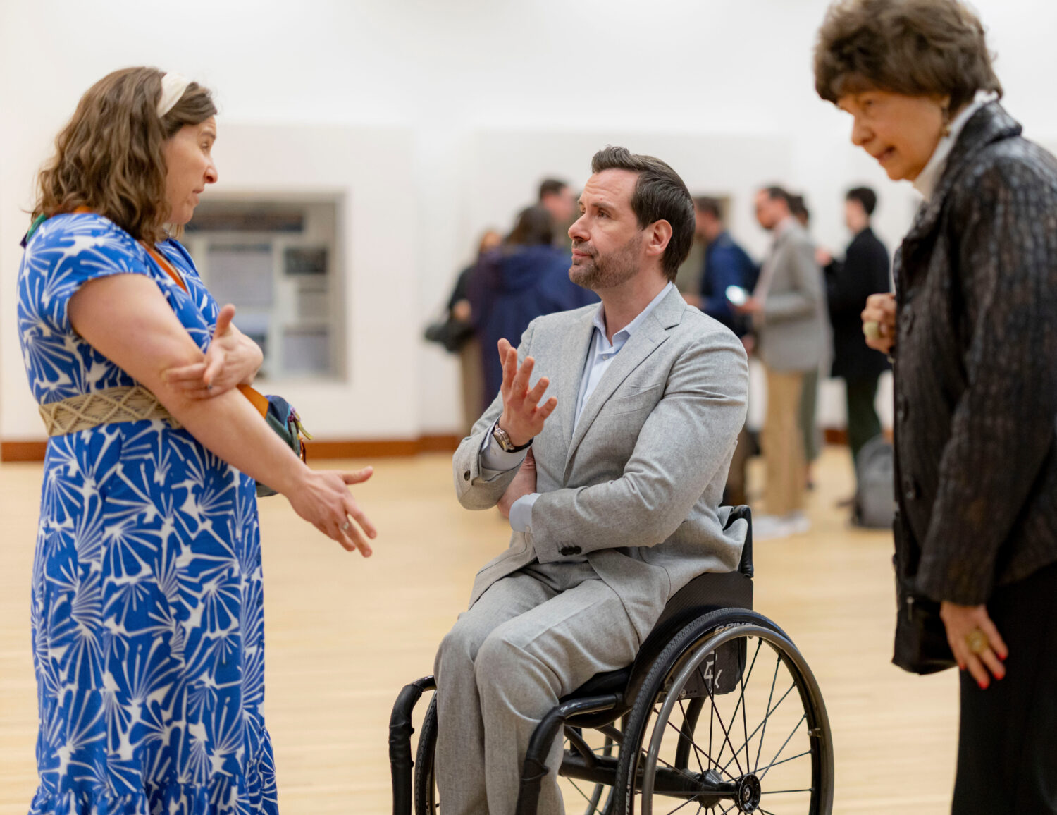 Iowa state Rep. Josh Turek talks with community members following a candidates forum at the State o...
