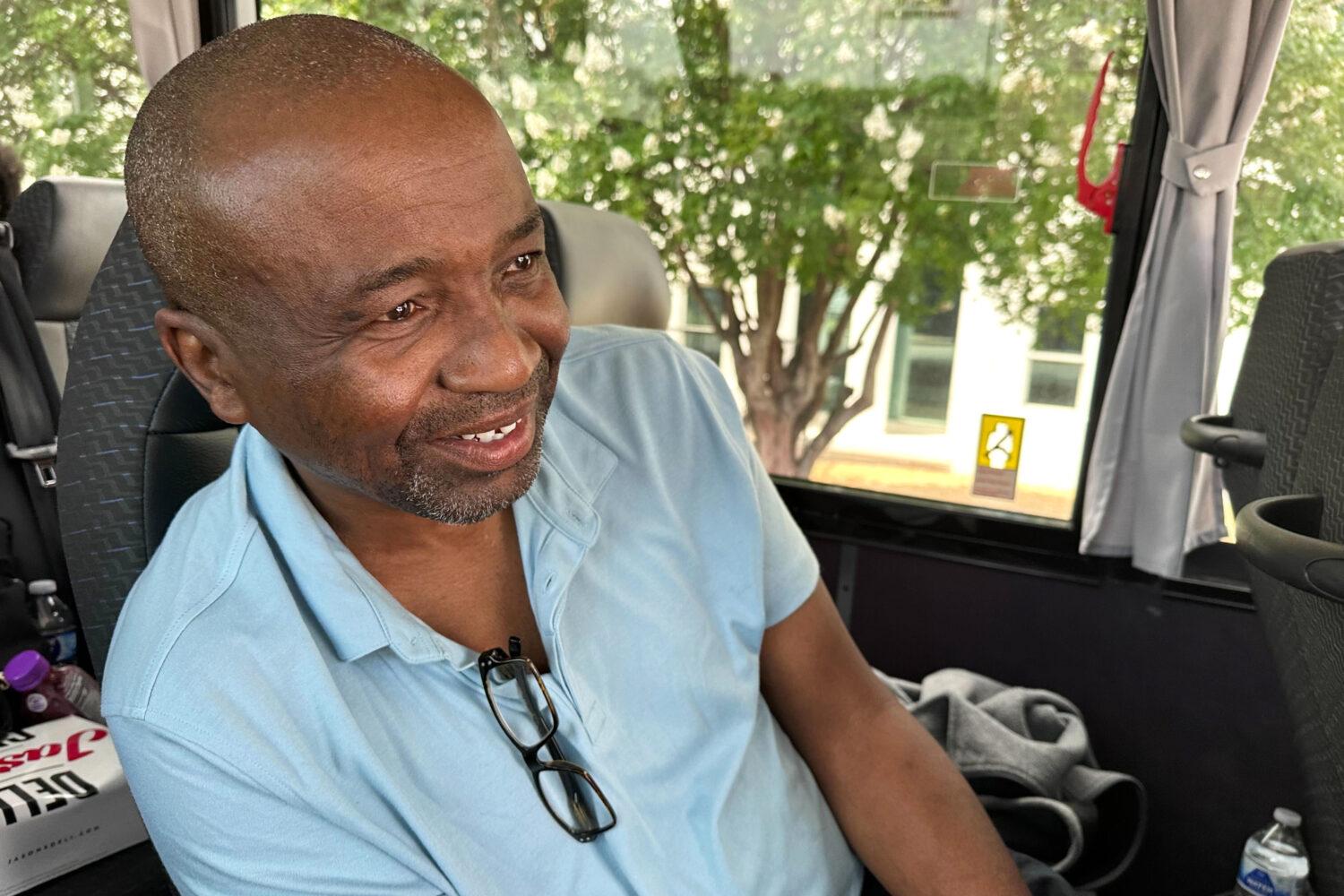 Keith Odom, a forklift driver from Aiken, S.C., looks out from his bus seat as he arrives in Montgo...