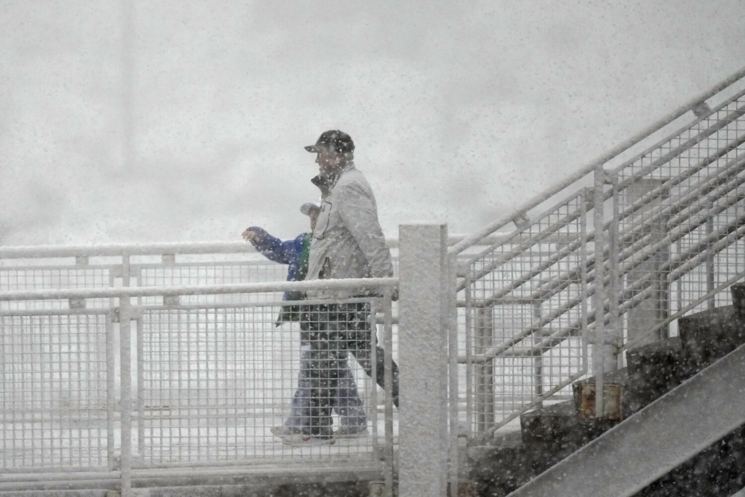 Hockey fans head into Ball Arena as a spring snow storm sweeps over the intermountain West before t...