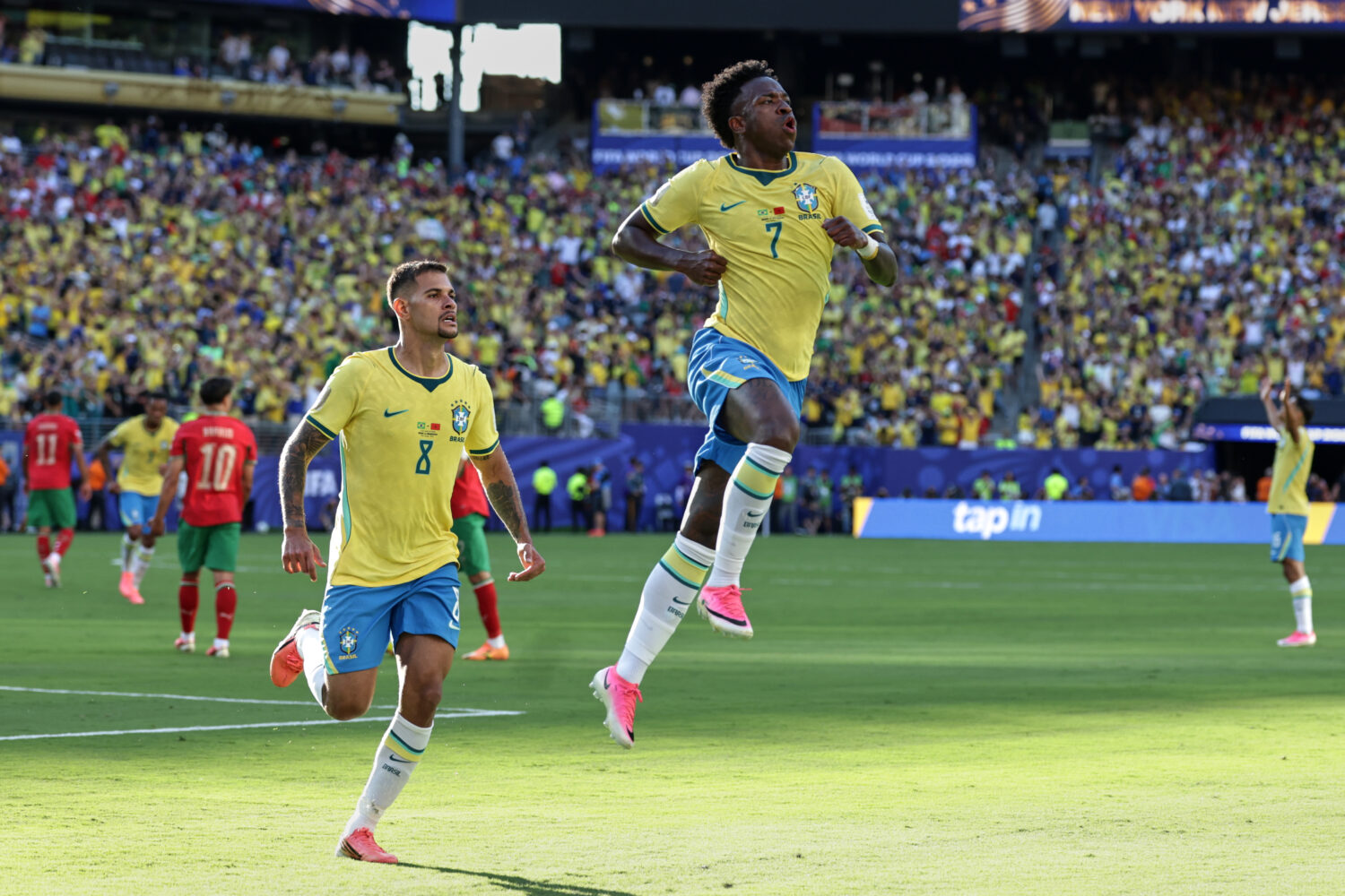 Brazil's Vinicius Junior (7) celebrates with teammate Bruno Guimaraes (8) after scoring during the ...