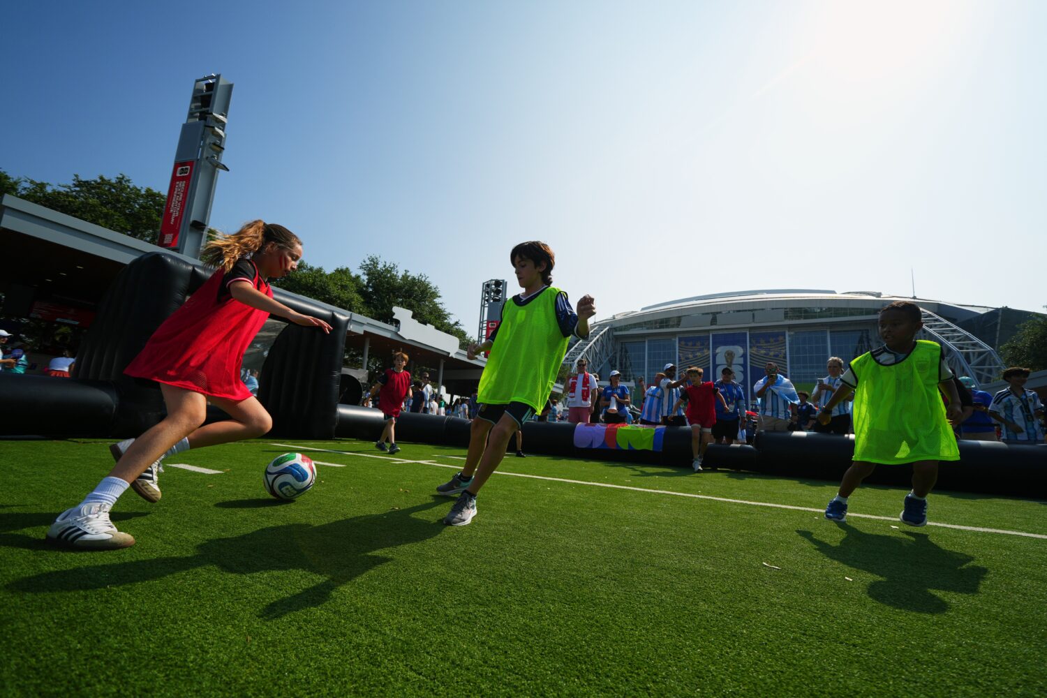 FILE - Children wearing shirts of Austria and Argentina play soccer outside the stadium before the ...