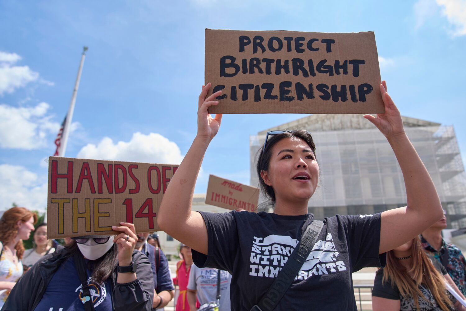 FILE - Hannah Liu, 26, of Washington, holds up a sign in support of birthright citizenship, May 15,...