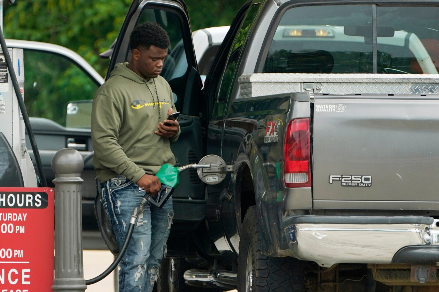 FILE - A customer prepares to pump diesel fuel at this Madison, Miss., Sam's Club, Tuesday, May 24,...