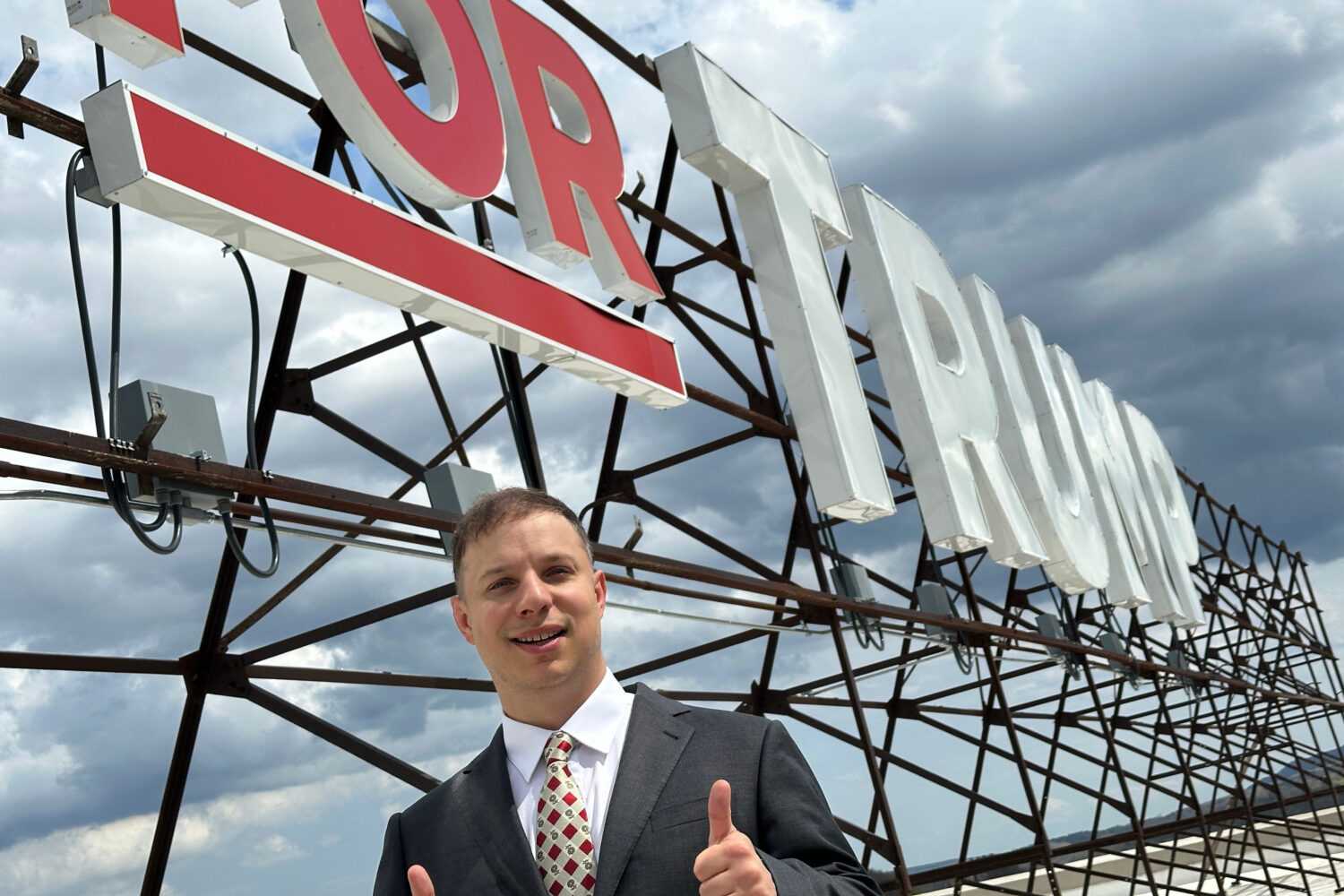 Anthony Constantino, a Republican candidate for Congress, stands next to the large "Vote for Trump"...