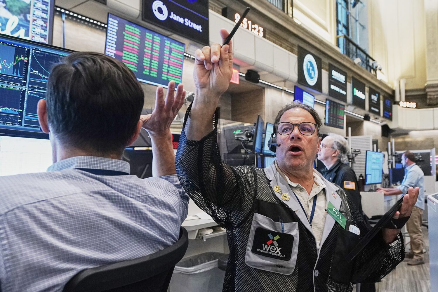 Options trader Anthony Spina, center, works on the floor of the New York Stock Exchange, Tuesday, J...