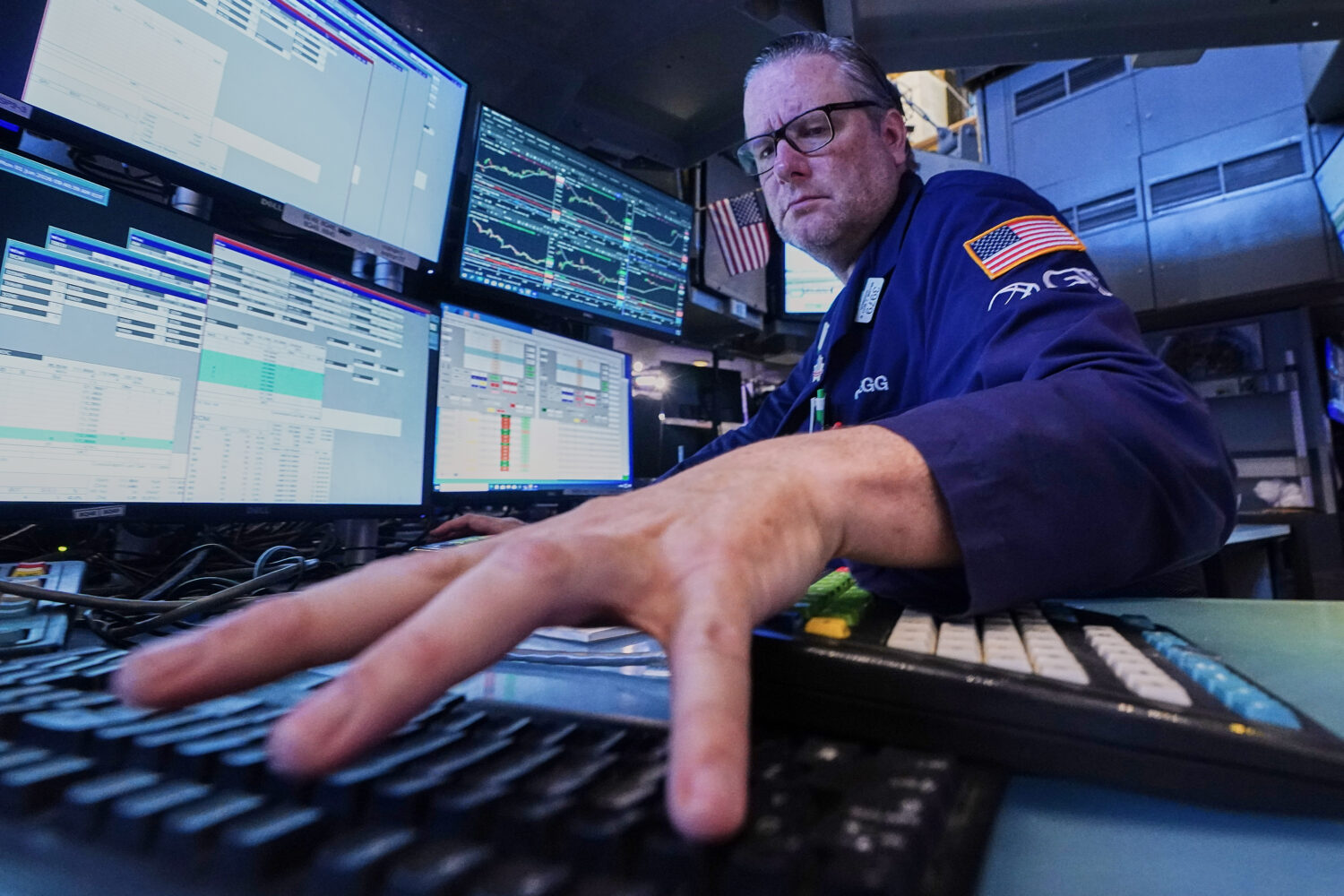 Specialist Gregg Maloney works at his post on the floor of the New York Stock Exchange, Monday, Jun...