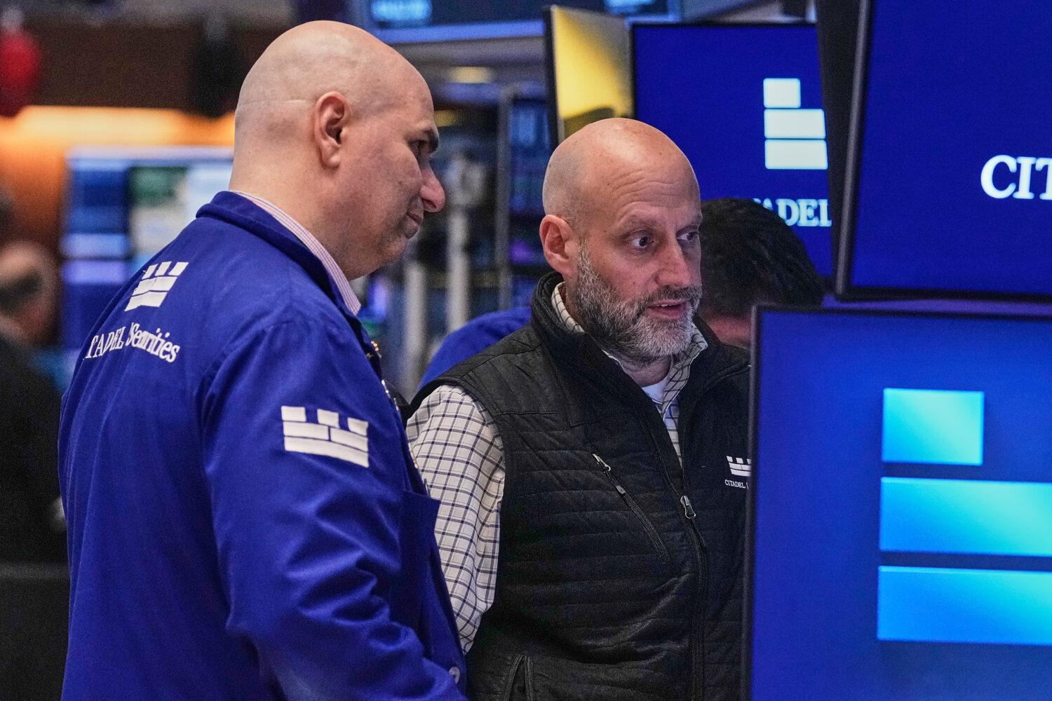Specialists Philip Finale, left, and Meric Greenbaum work on the floor of the New York Stock Exchan...