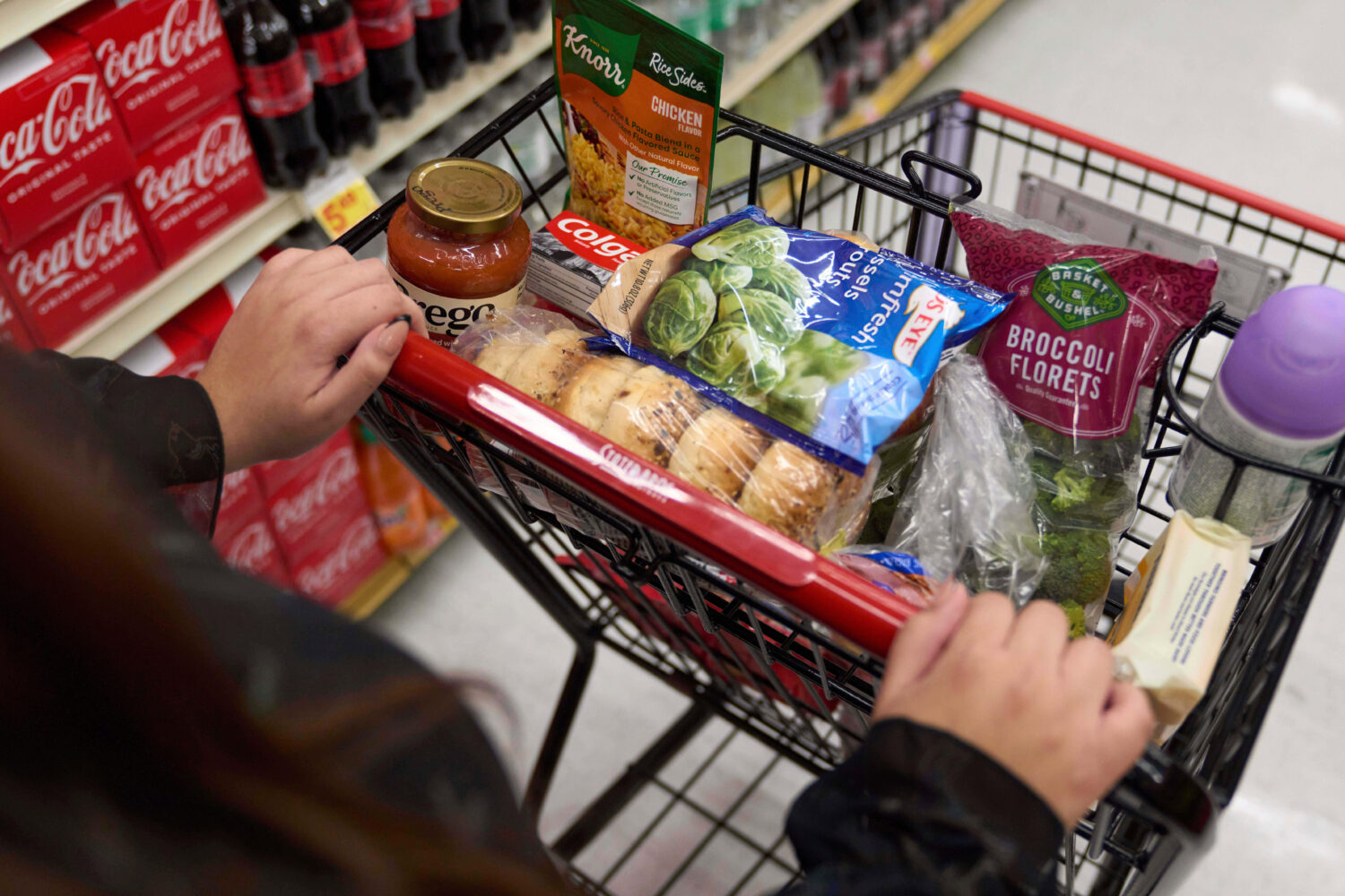 FILE - A California's SNAP benefits shopper pushes a cart through a supermarket in Bellflower, Cali...