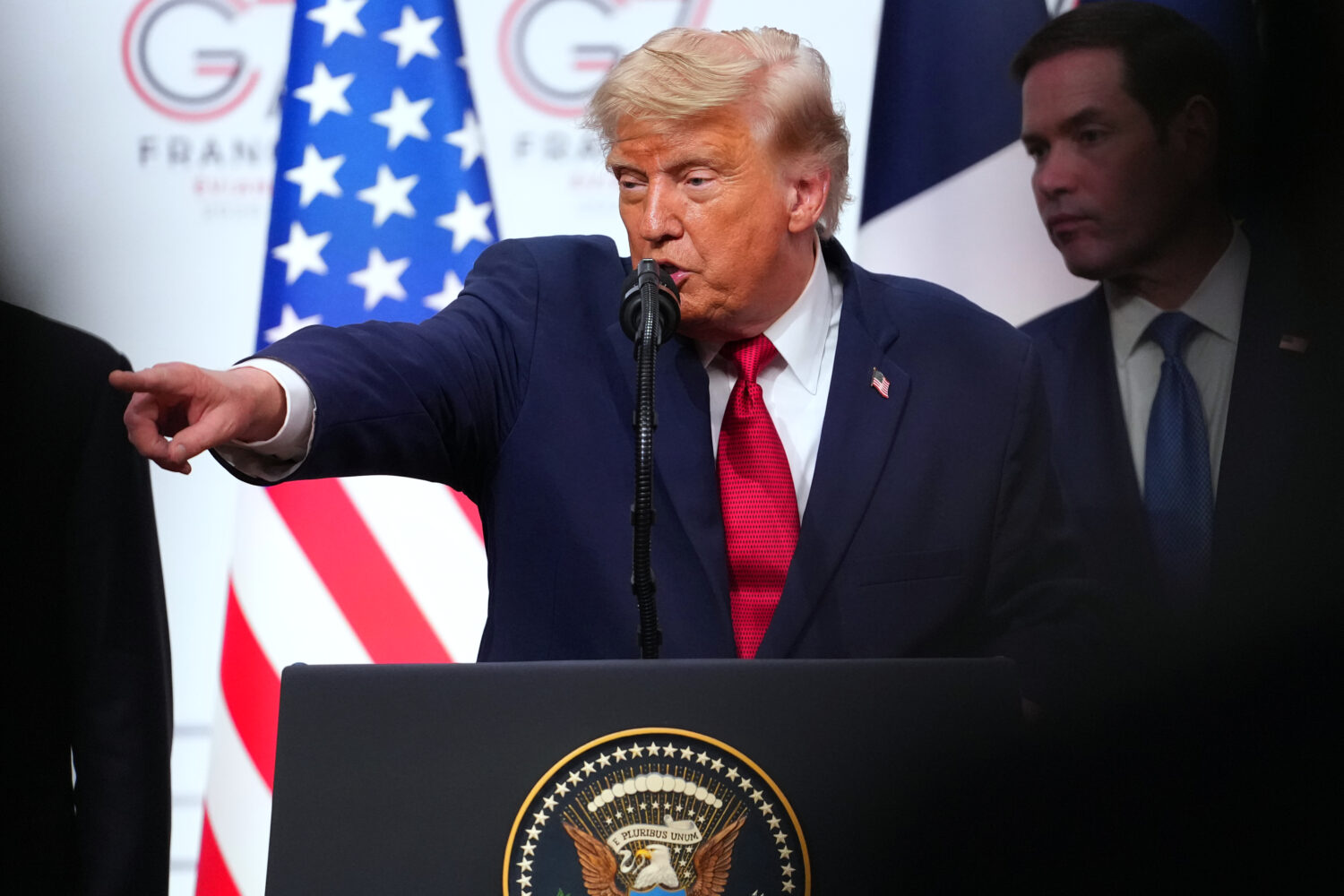 U.S. President Donald Trump, center, takes questions during a media conference at the end of the G7...