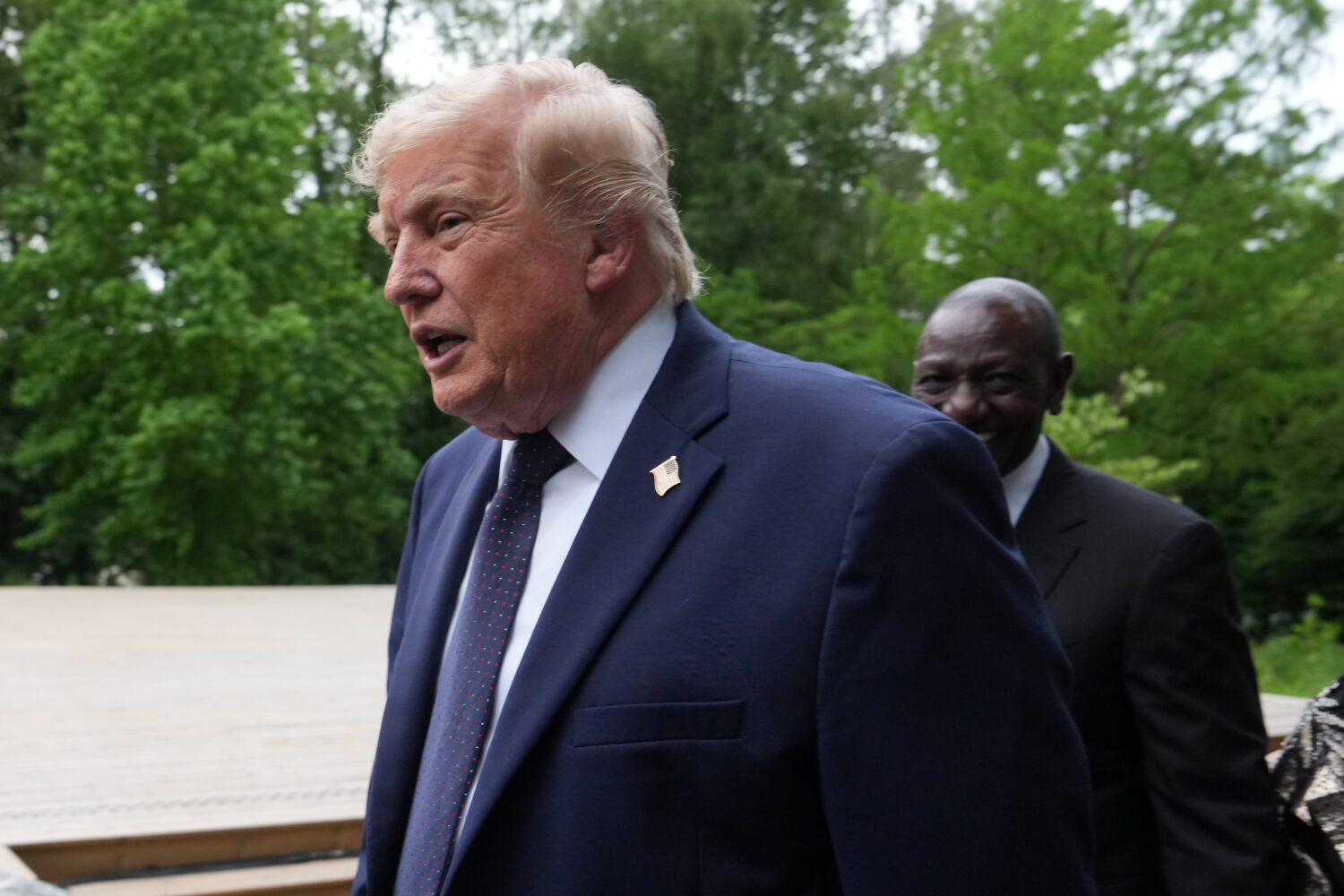 U.S. President Donald Trump walks away after a group photo of leaders at the G7 summit, Tuesday, Ju...