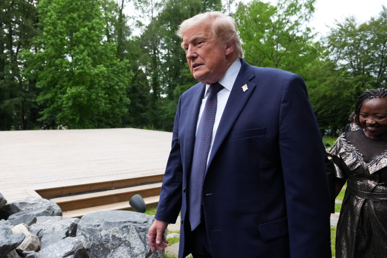 U.S. President Donald Trump walks away after a group photo of leaders at the G7 summit, Tuesday, Ju...