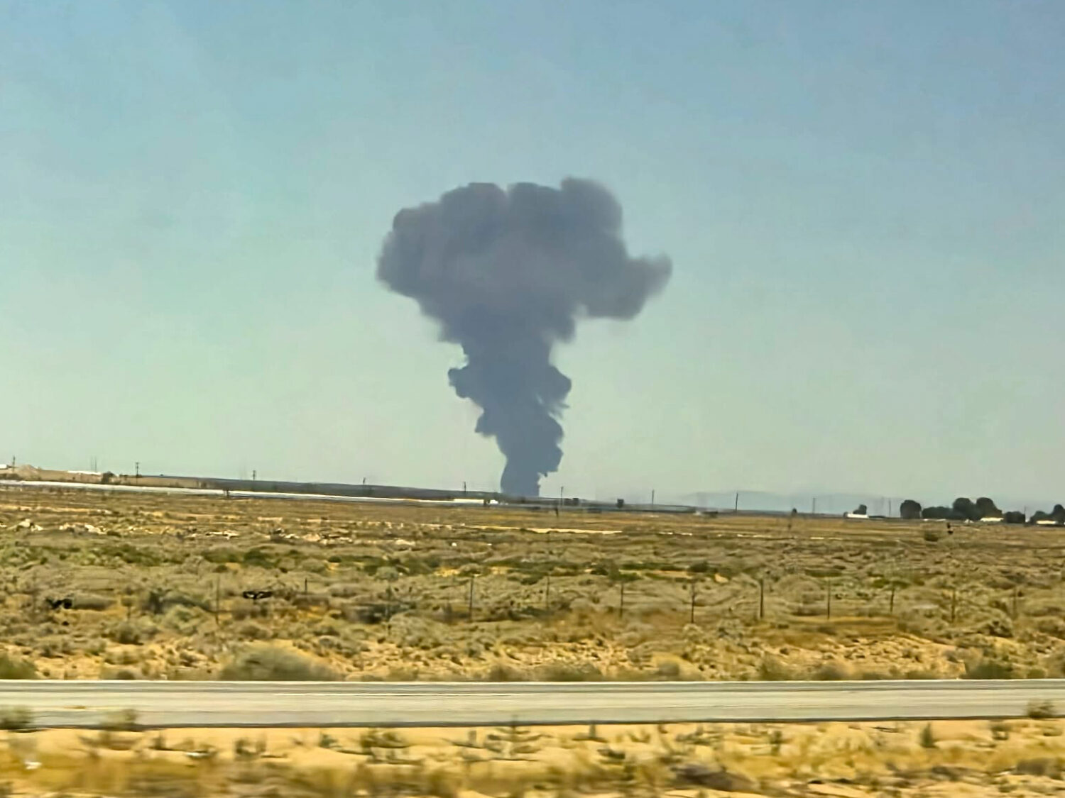 Smoke plumes rise from a B-52 bomber that crashed shortly after takeoff at a U.S. Air Force base in...