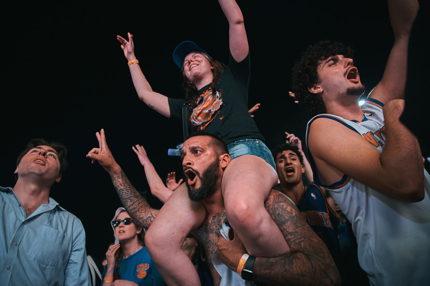 New York Knicks fans celebrate as they watch Game 5 of the NBA Finals basketball series against the...