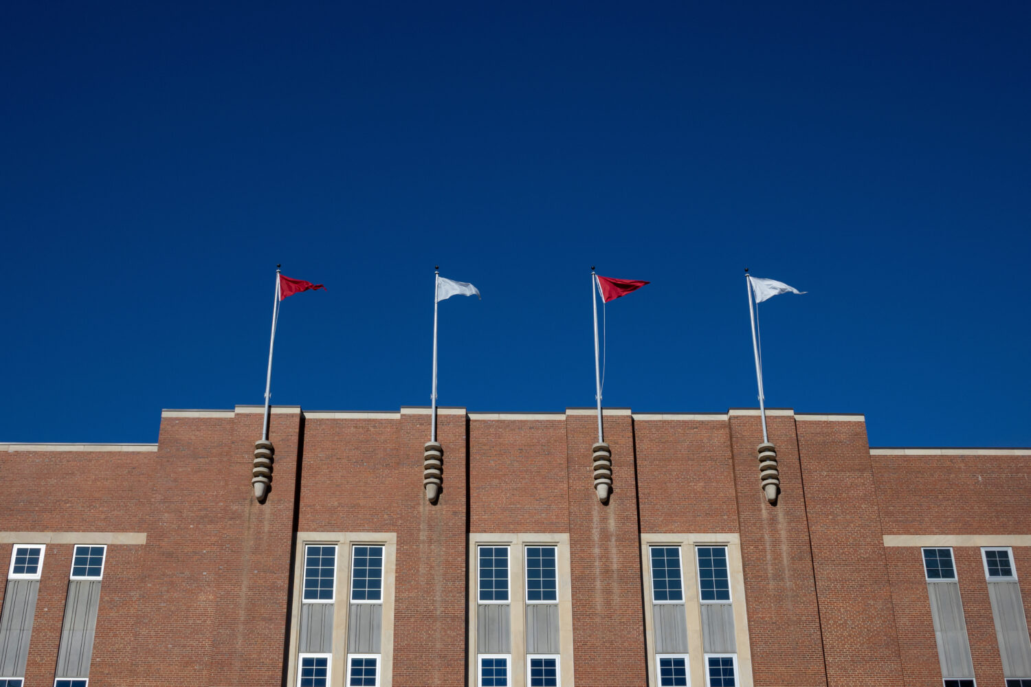 FILE - Flags fly above at the Reynolds Coliseum on the campuse of North Carolina State University, ...