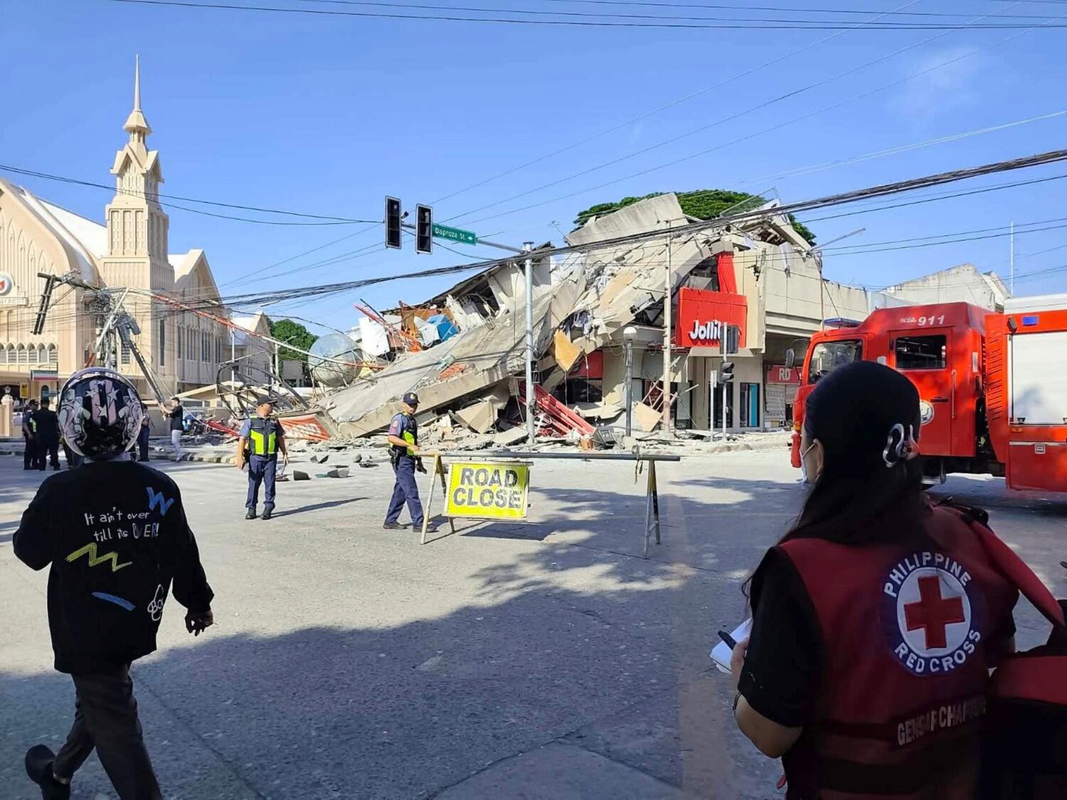 In this photo provided by the Philippine Red Cross, rescuers inspect the damage after an earthquake...