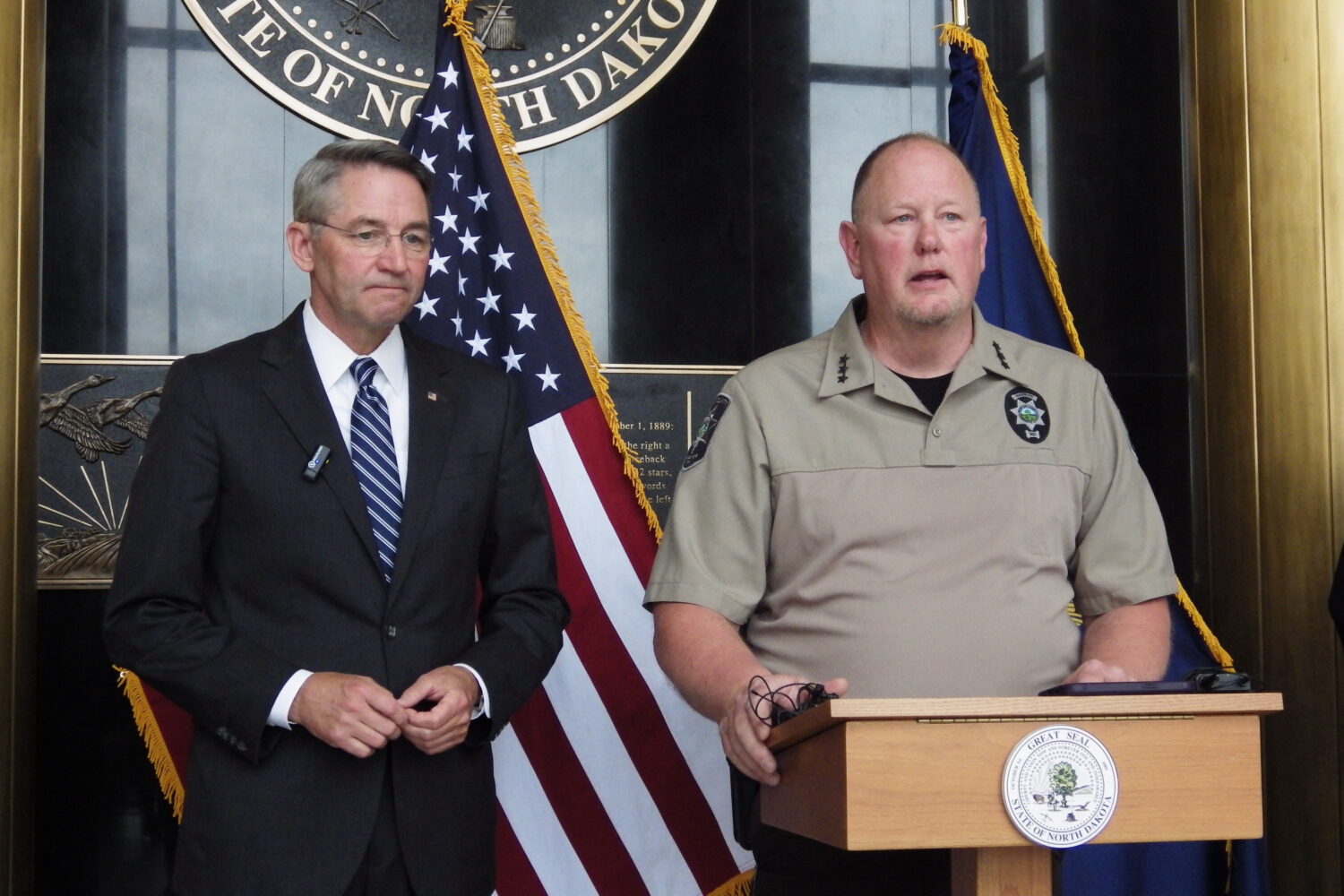 North Dakota Republican Attorney General Drew Wrigley, left, listens as Morton County Sheriff Kyle ...