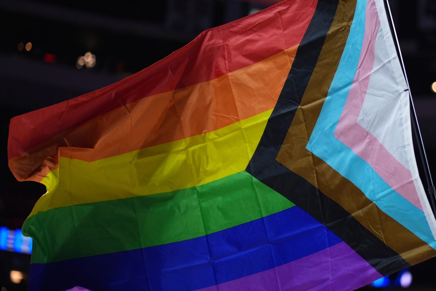 FILE - A pride flag is waved during an NBA basketball game in Philadelphia on Sunday, March 30, 202...