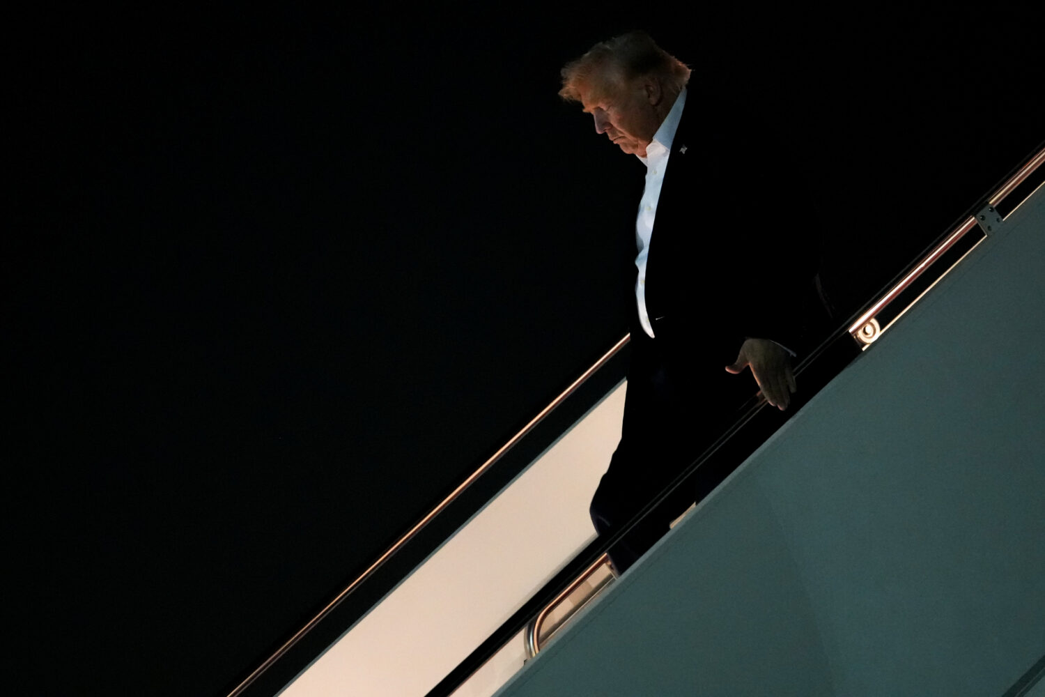 President Donald Trump disembarks Air Force One after attending the G7 summit in France, Thursday, ...