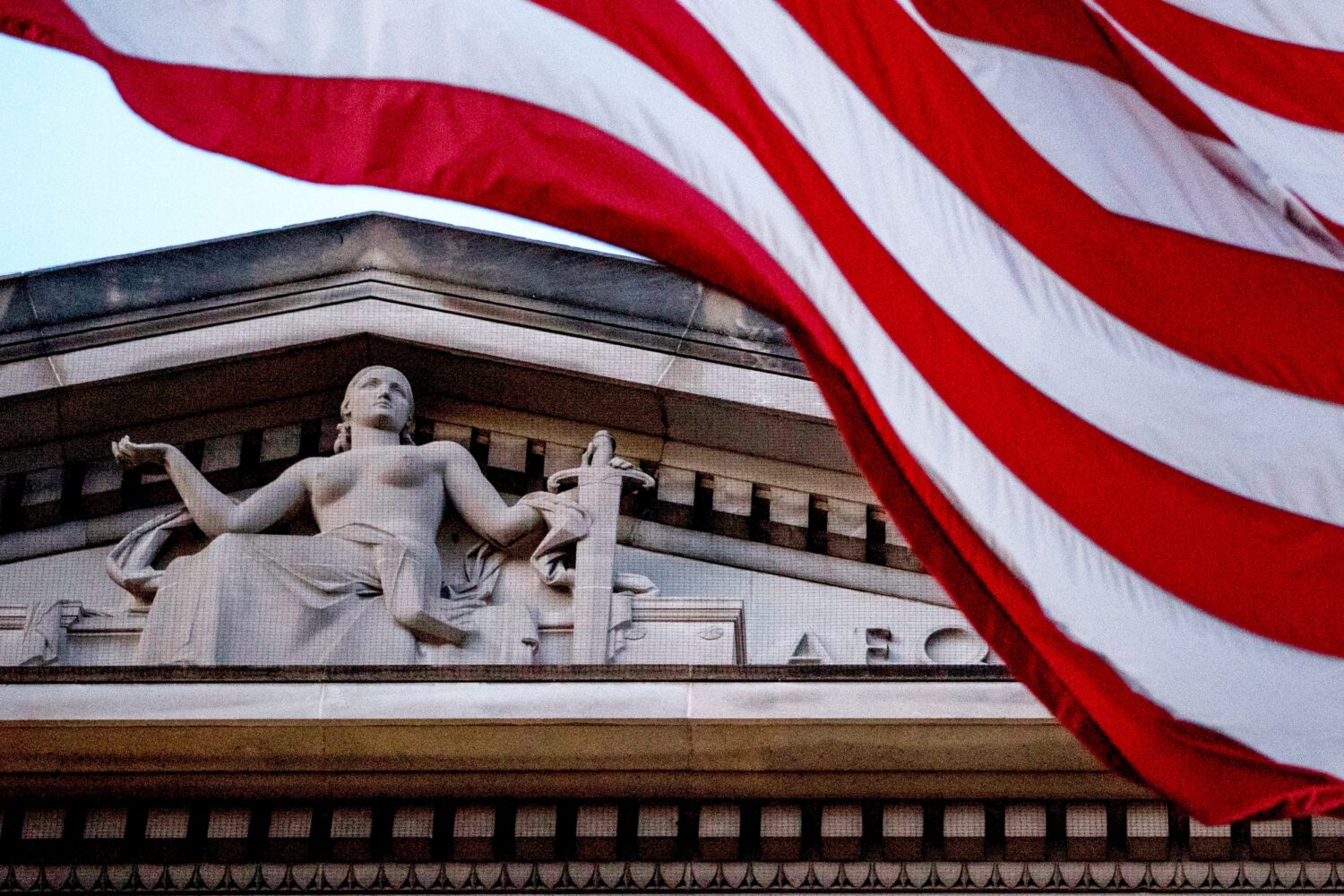 FILE - An American flag flies outside the Department of Justice in Washington, March 22, 2019. (AP ...