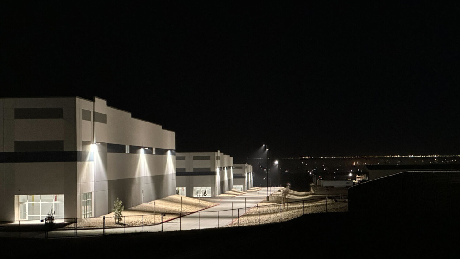 FILE - A massive 826,780-square-foot warehouse sits illuminated Feb. 12, 2026, in the El Paso subur...