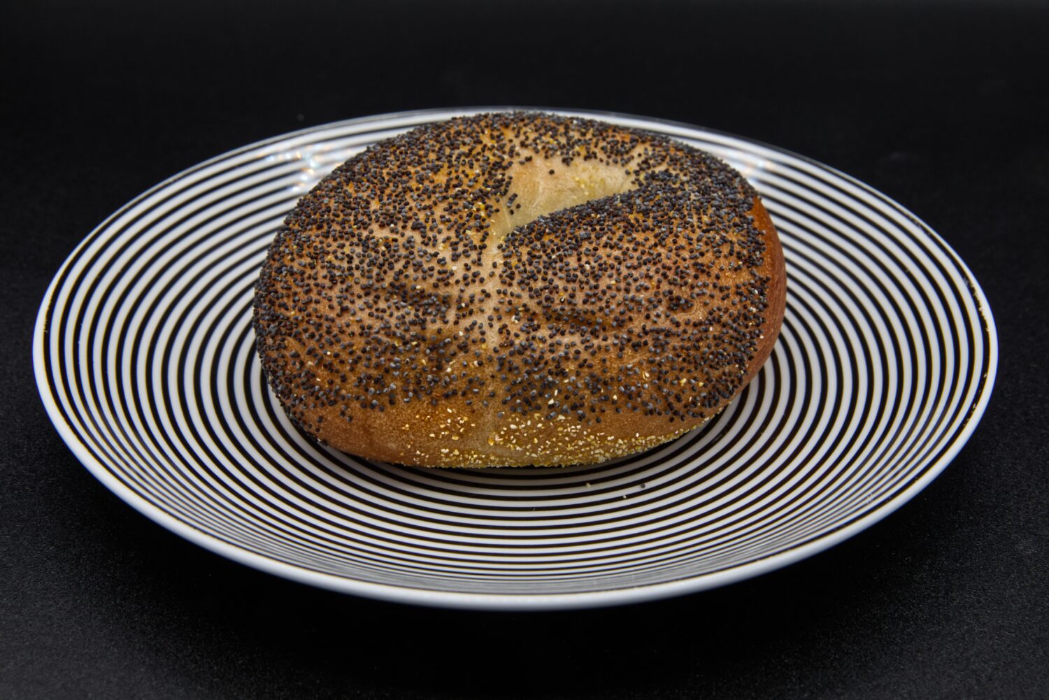 A poppy seed bagel on a plate photographed in Phoenix, Ariz., Monday, July 20, 2026. (AP Photo/Dari...