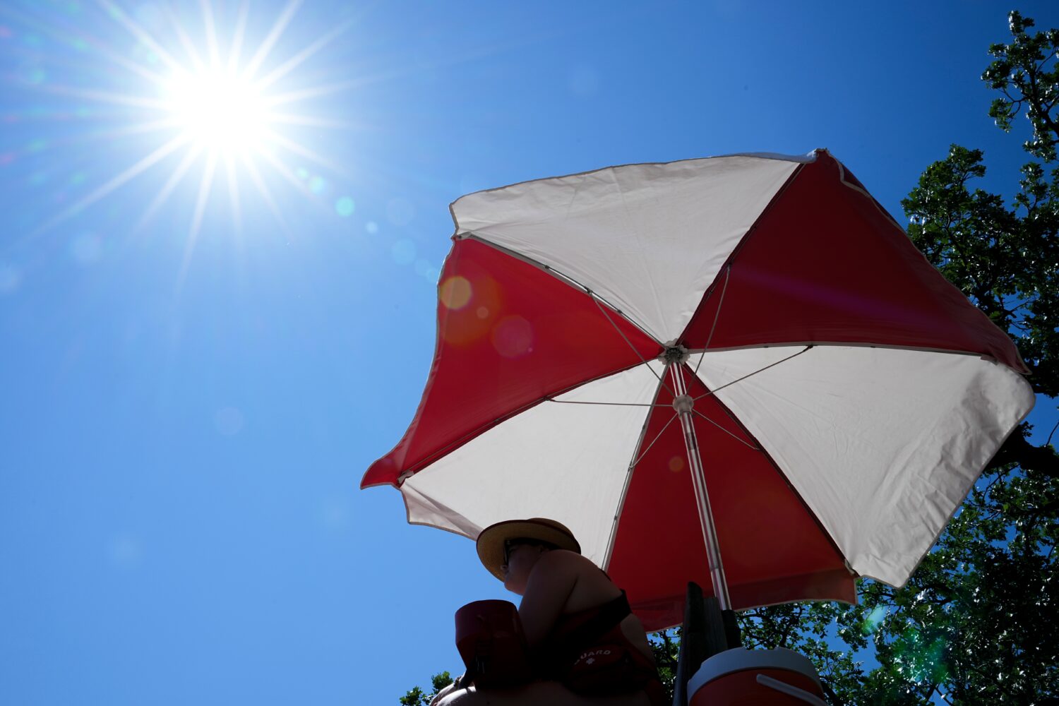 The sun beams down on a lifeguard while she watches over a beach at Lake Harriet during an extreme ...