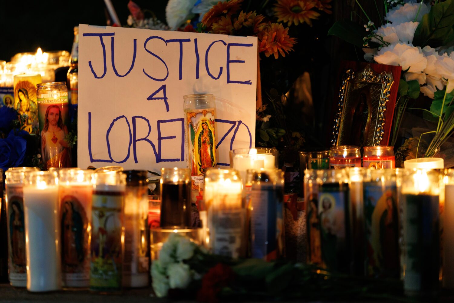Candles are lit during a vigil for Lorenzo Salgado Araujo, a Mexican national fatally shot by a fed...