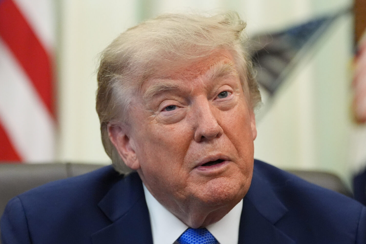 President Donald Trump speaks before signing executive orders in the Oval Office of the White House...